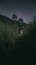 Man standing on field against sky