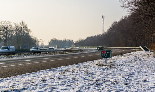 View of snow covered road against sky