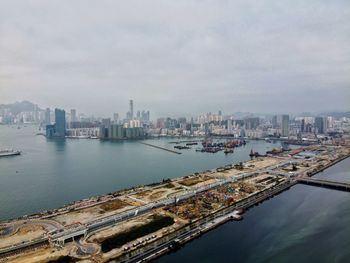 Aerial view of buildings and sea against sky