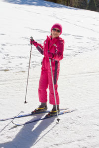 Teenage girl skiing on snow covered land