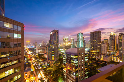 High angle view of illuminated buildings against sky at night