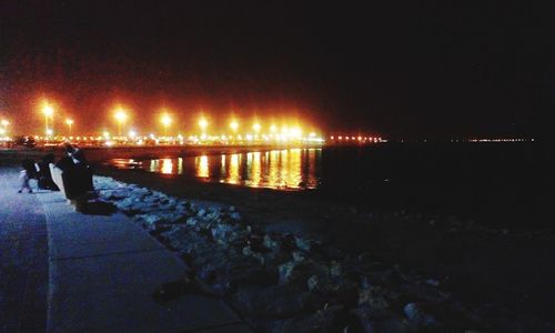 Reflection of illuminated lights in puddle