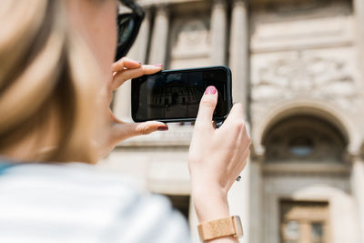 Midsection of woman using mobile phone