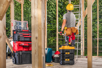 Rear view of man standing in factory