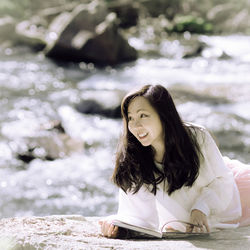 Portrait of young woman standing outdoors