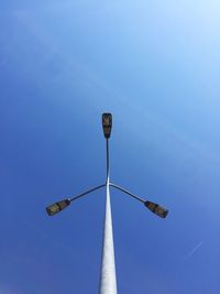 Low angle view of tall building against clear blue sky