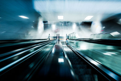 Blurred motion of illuminated escalator