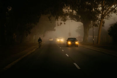 Silhouette of car on road at night