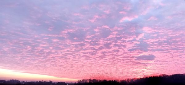 Low angle view of dramatic sky during sunset