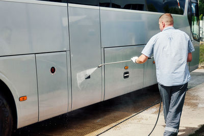 Rear view of man standing on road