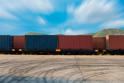 Freight train in shunting yard against blue sky