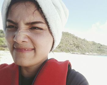 Close-up portrait of young woman on beach