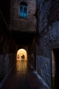 Narrow alley amidst old buildings in city