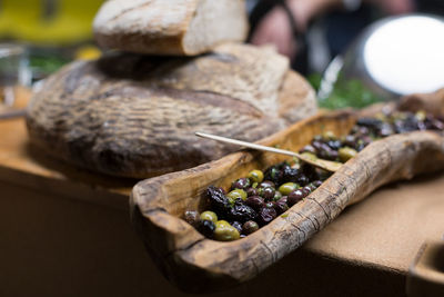 High angle view of olives on wood