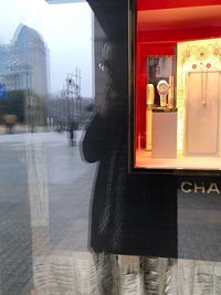 Reflection of woman on glass window