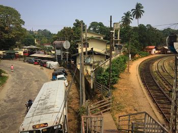 Vehicles on road along buildings in city