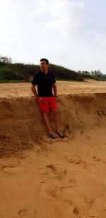 Full length of man standing on land against sky