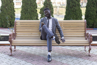 Man sitting on bench in park