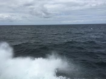 Scenic view of sea against cloudy sky