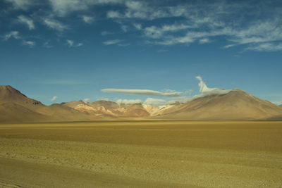 Scenic view of mountains against cloudy sky