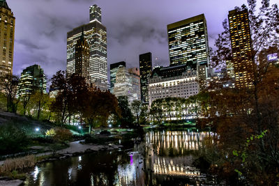 Reflection of illuminated buildings in city at night