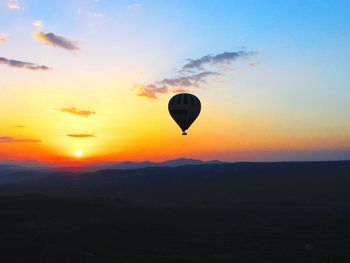 Hot air balloon flying over landscape