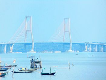 Sailboats on sea against clear blue sky