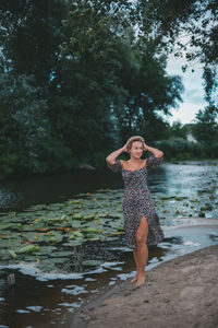 Portrait of young woman standing in water