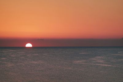 Scenic view of sea against romantic sky at sunset