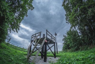 Traditional windmill in park against sky