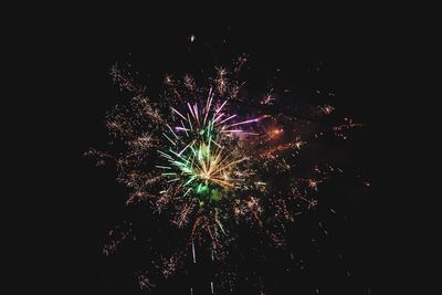Low angle view of firework display at night