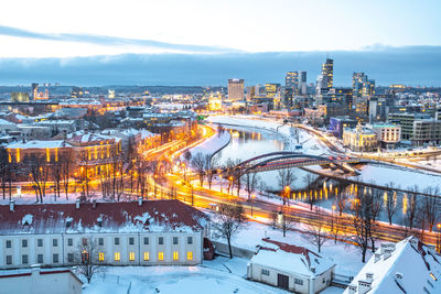 High angle view of illuminated buildings against sky during winter