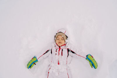 Portrait of smiling girl playing with toy on snow