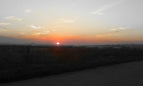 Scenic view of landscape against sky during sunset