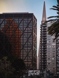 Interesting orange reflection of embarcadero center building in the windows of one maritime plaza