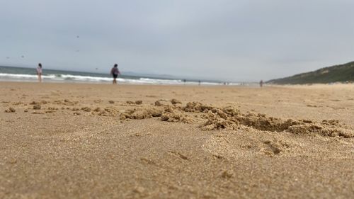 Surface level of beach against sky