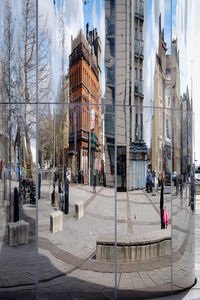 Reflection of buildings and street on glass