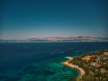 Scenic view of sea against clear blue sky