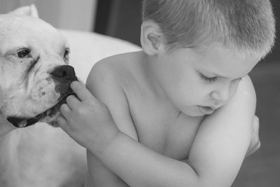 Cute girl holding dog at home