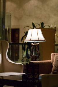 Close-up of electric lamp on table at home