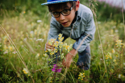 Full length of boy on flower field