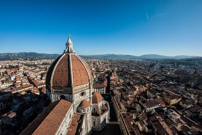 Aerial view of city against clear blue sky