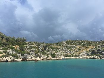 Scenic view of sea and mountain against sky