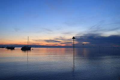 Scenic view of sea against sky at sunset