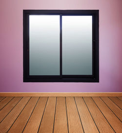 Low angle view of hardwood floor against wall
