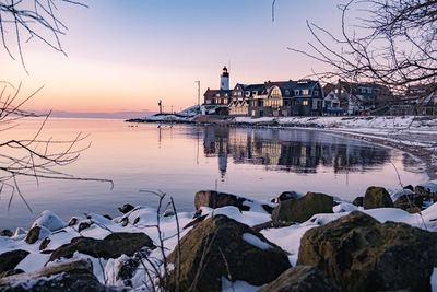 Scenic view of frozen lake against sky during sunset