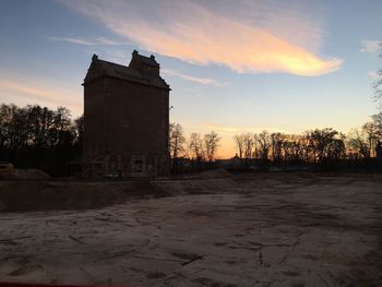 Old building against sky during sunset