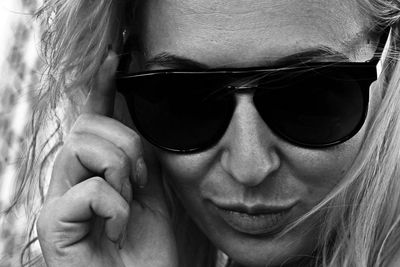 Close-up portrait of woman wearing sunglasses