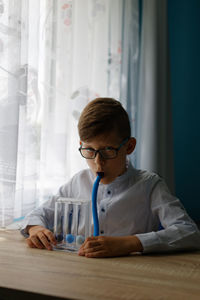 Portrait of young man sitting on table