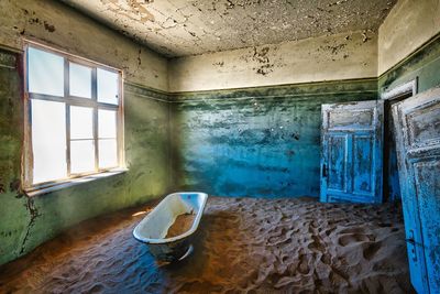 Bathtub and sand in abandoned building